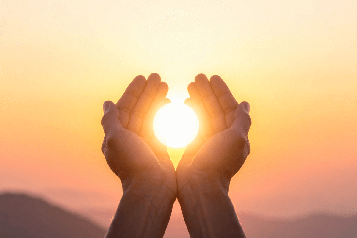 Healing and purpose – hands holding radiant orb of golden light, symbolizing alignment, hope, and spiritual healing.